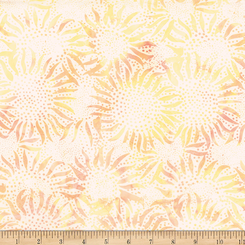 Fabric with sunflower pattern in orange and yellow on a beige background, measured with a ruler at the bottom.